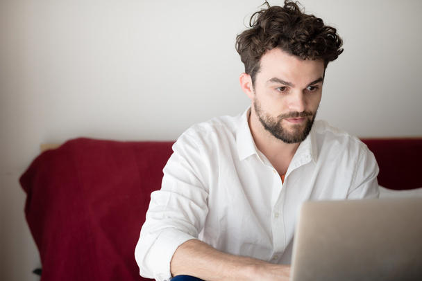 handsome hipster modern man working home using laptop - Foto, Bild
