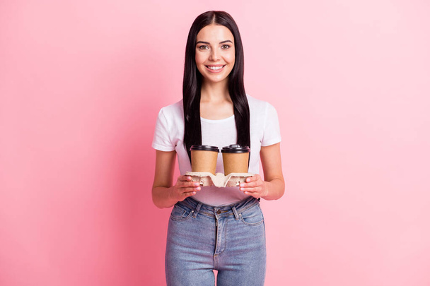 Photo of optimistic brunette lady hold coffee wear white t-shirt isolated on pastel pink color background - Φωτογραφία, εικόνα