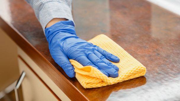 Woman wiping table countertop in kitchen by wet cloth rag. Female charwoman hand cleaning disinfect office home restaurant surfaces. Long web banner - Foto, Imagen