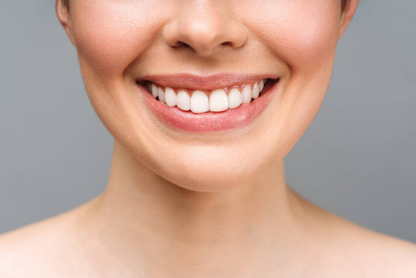 Perfect healthy teeth smile of a young woman. Teeth whitening. Dental clinic patient. Image symbolizes oral care dentistry, stomatology - 写真・画像