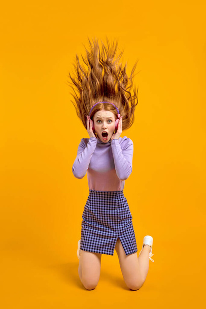 Excited Funny Female With Flying Long Red Hair Is In Shock By Listening Music So Loud - Φωτογραφία, εικόνα