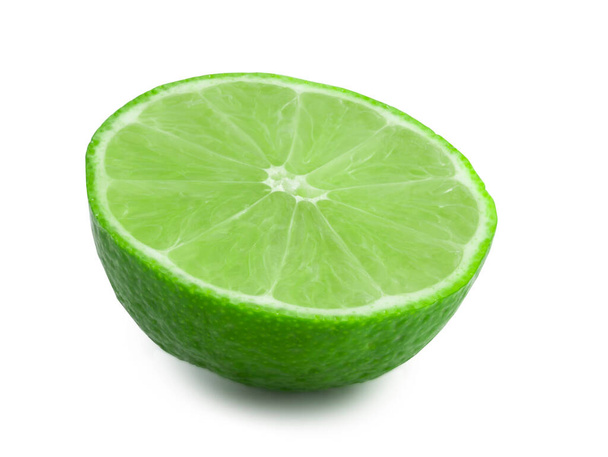Half of lime isolated on white background. Fresh citrus in the cut. Green fruit full focus - Photo, Image