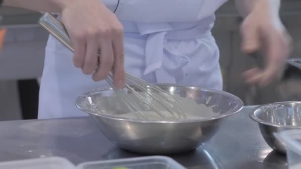 Close up: baker holding balloon whisk and preparing whipped sweet cream - Footage, Video