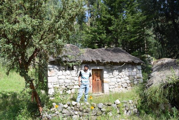 Joven posando en la puerta de su casa en el campo - Φωτογραφία, εικόνα