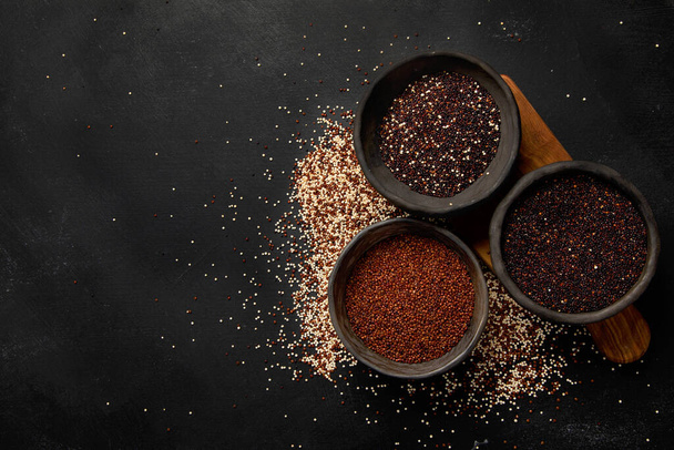 Set with different types of quinoa on dark background. Organic food concept. Top view, copy space - Photo, Image