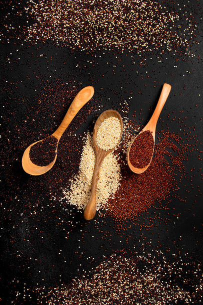 Set with different types of quinoa on dark background. Organic food concept. Top view - Photo, Image