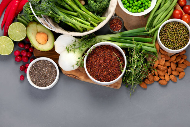 Assorted vegetables and cereal on gray background. Healthy food concept. Top view, copy space - Foto, afbeelding