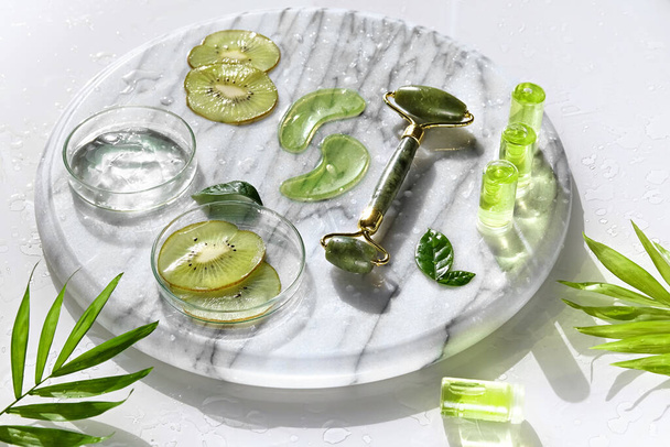 Cosmetic skincare background. Herbal medicine with kiwi slices and palm leaves. Homemade sugar scrub. Natural sunlight, shadows. Splashes, water circles around. Natural body care . - Fotoğraf, Görsel