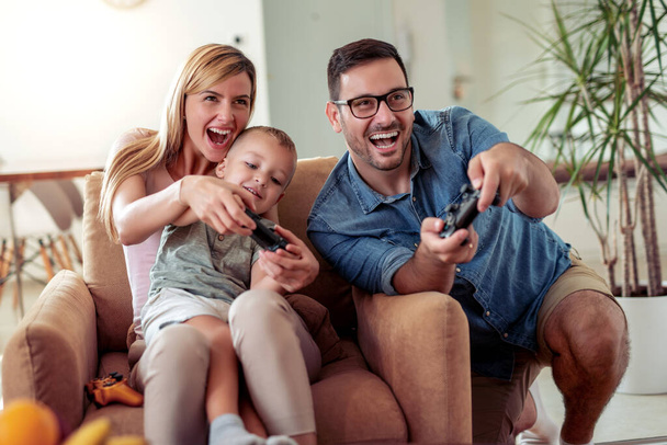 Happy loving  family play video games together. - Fotó, kép