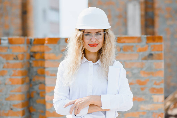 Portrait of confident female construction worker at construction site - Fotó, kép