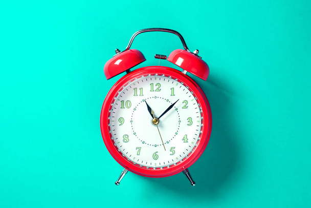 Red alarm clock on the color background.  - Photo, Image
