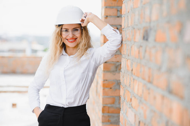 A portrait of engineer woman looking construction. Concept Engineer and business work. - Фото, изображение