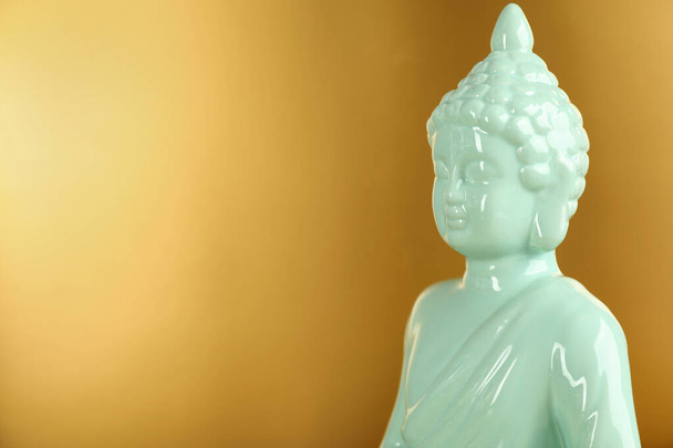 Buddha statue on golden background, closeup. Space for text - Фото, зображення