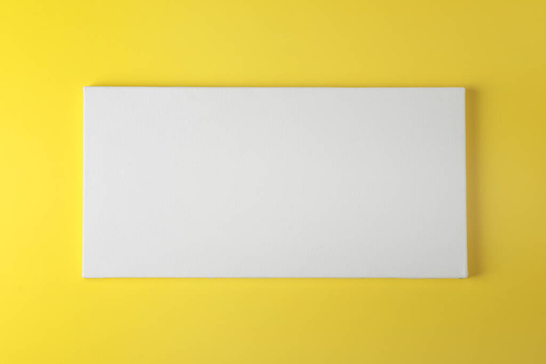 Blank canvas on yellow background, space for text - Φωτογραφία, εικόνα