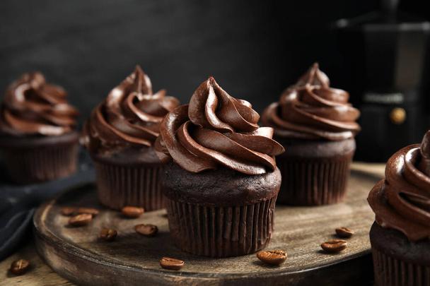 Delicious chocolate cupcakes with cream on wooden table - Φωτογραφία, εικόνα