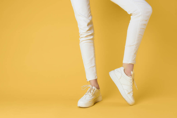 white sneakers posing modern stylish yellow background - 写真・画像