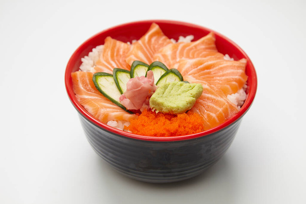 Salmon donburi or slice raw salmon put on cooked rice on white background. - Fotoğraf, Görsel