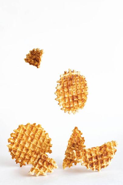 Belgian traditional waffles, creative composition on a light background. Levitating waffles. Minimalism style, selective focus, copy space. - Zdjęcie, obraz