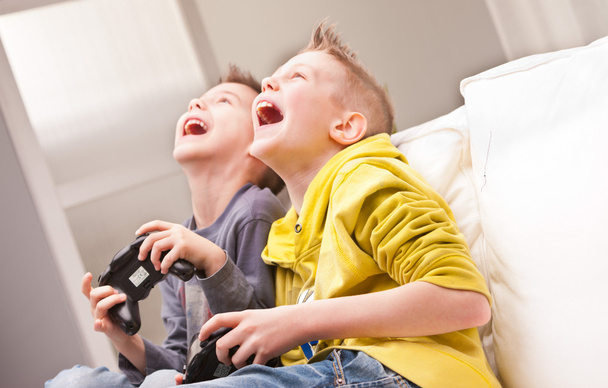 two kids playing video games - Photo, Image