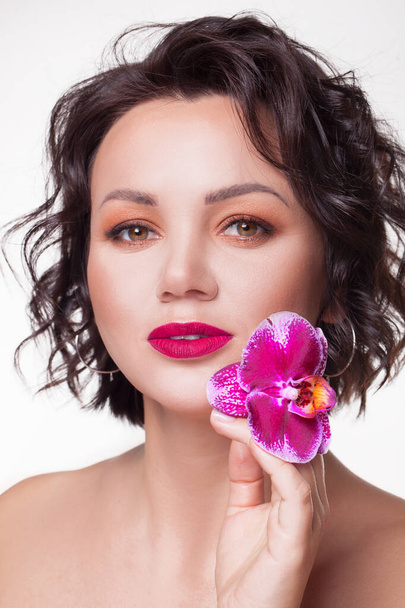 Beautiful portrait girl with flower orchid lips Fashion Beauty  - Zdjęcie, obraz