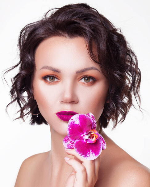 Beautiful portrait girl with flower orchid lips Fashion Beauty  - Photo, image
