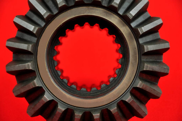 Metal  cogwheel on the red background.  - Фото, изображение