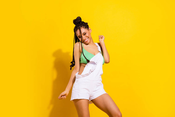 Photo of charming joyful dark skin young woman enjoy summer good mood isolated on yellow color background - Foto, Imagem