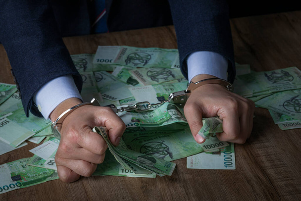 business crime concept, handcuffed criminal in suit - Foto, imagen