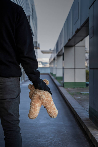 criminal with teddy bear - Foto, afbeelding