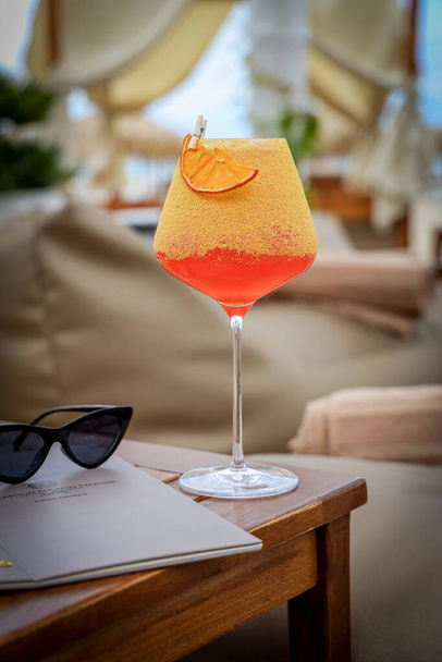 A vertical shot of a glass filled with a delicious cool fruity cocktail - Zdjęcie, obraz