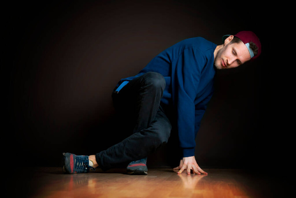 closeup photo of male break dancer performing stance against dark background b - Photo, Image