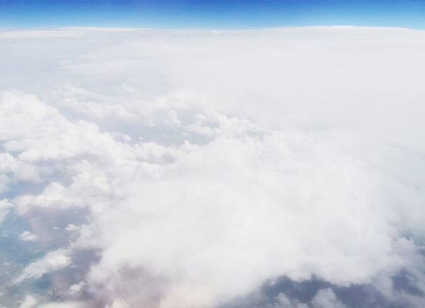 A beautiful view from above dense fluffy clouds in the blue sky - perfect for wallpapers - Fotó, kép