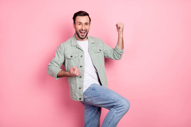 Portrait of attractive cheerful lucky guy dancing rejoicing having fun isolated over pink pastel color background - 写真・画像