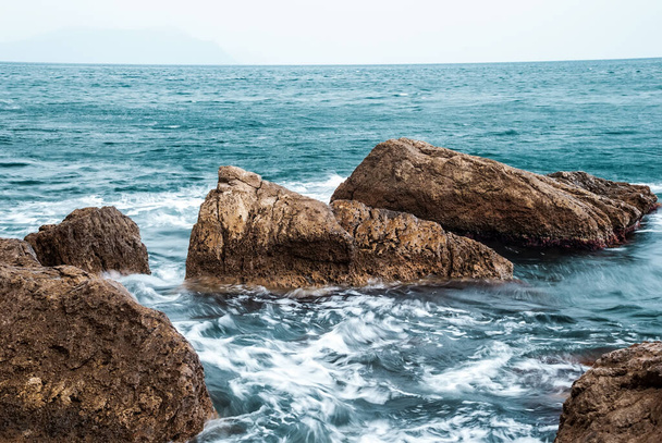 Seascape of the Crimean coast. Waves break into beautiful splashes against rocks. - Zdjęcie, obraz