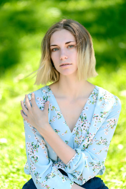 Outdoors portrait of beautiful young woman with green eyes. - 写真・画像