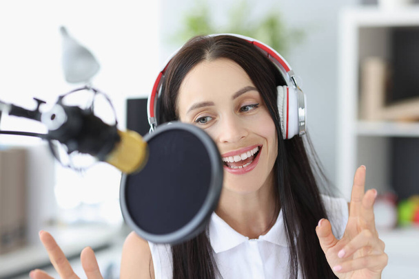 Portrait young woman recording podcast in studio. - Fotografie, Obrázek