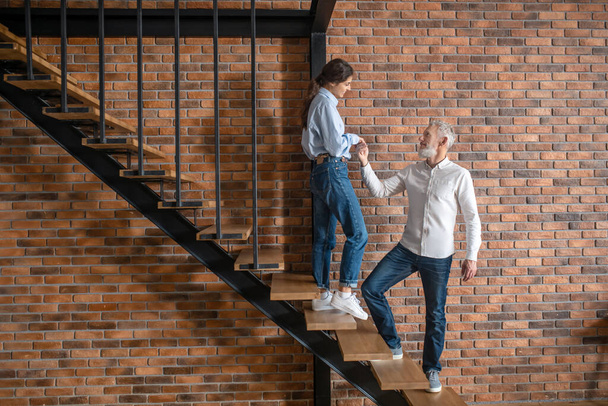 A man and a woman standing on the stairs and looking at each other - Fotoğraf, Görsel