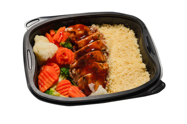 Ready food in a container. Stewed chicken in teriyaki sauce, stewed carrot, cabbage and porridge. Isolated on a white background.  - Φωτογραφία, εικόνα