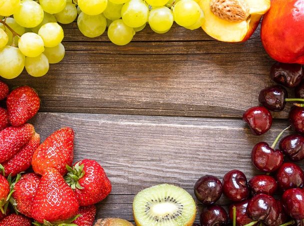fresh fruits on a wooden background with a copy space. - Foto, imagen