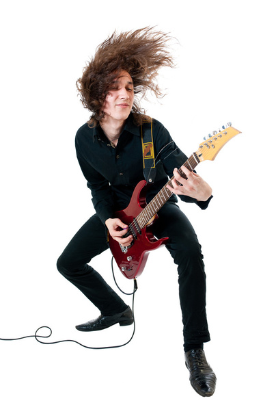Young guitarist with red guitar on white background - Fotoğraf, Görsel