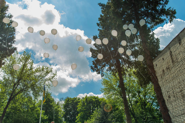 many white balloons flying in blue sky - Photo, Image