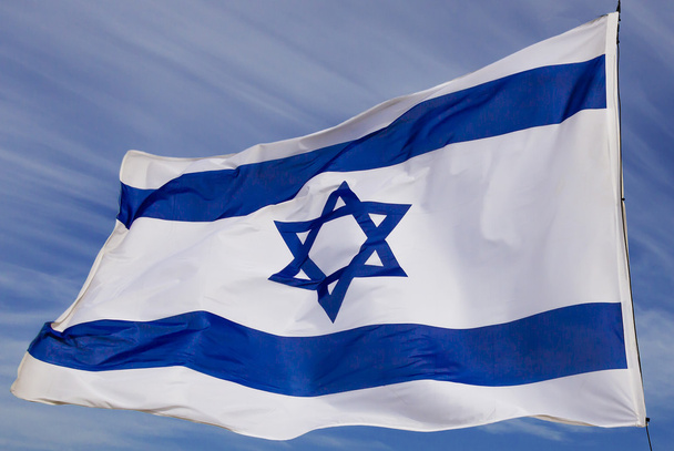 Israel flag flapping in the wind isolated against the sky - Foto, Bild