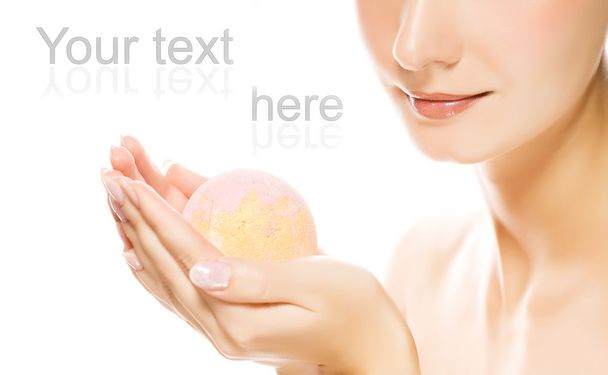 Lovely young woman with aroma bath ball in her hands - Photo, Image