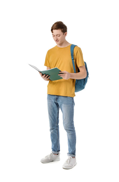 Männlicher Student mit Buch auf weißem Hintergrund - Foto, Bild