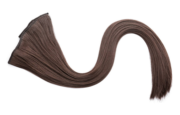 Strand of brown hair on white background - Photo, image