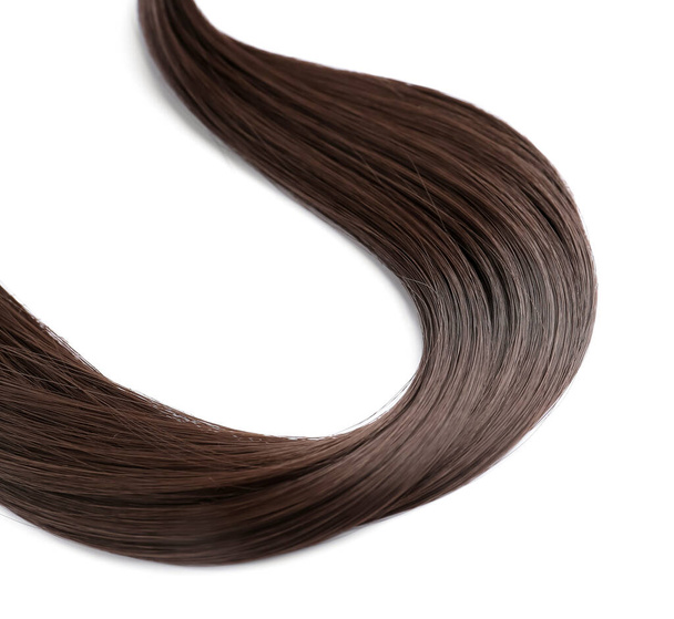Strand of brown hair on white background - Foto, imagen
