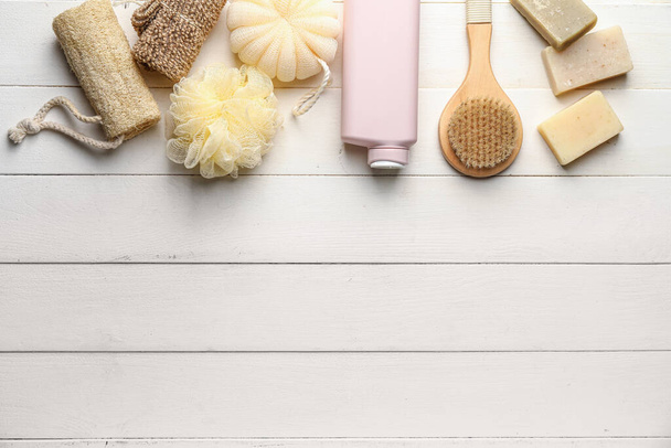 Bottle of shower gel and bath supplies on light wooden background - Photo, Image
