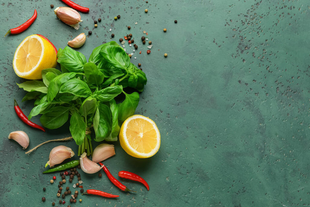 Fresh basil leaves, lemon and spices on color background - Photo, Image