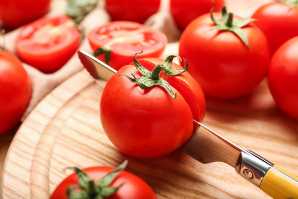 Board with fresh ripe tomatoes, closeup - 写真・画像