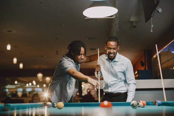 Men playing billiards in a club - Фото, изображение